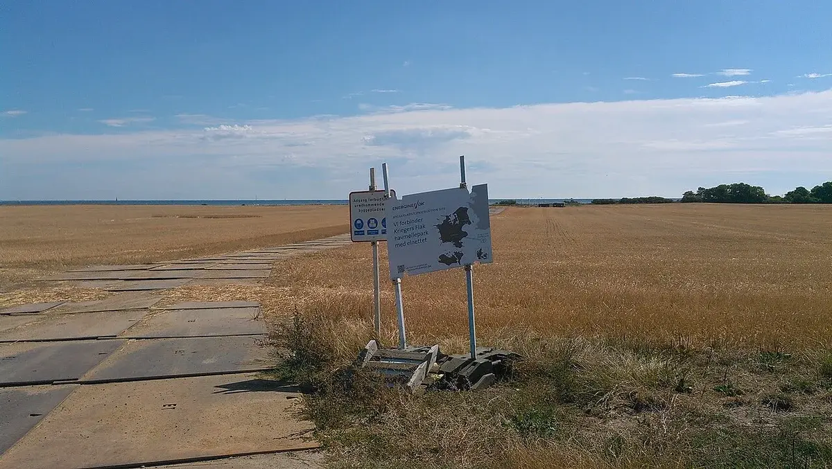 Construction signs beside a temporary path across a field in Denmark.