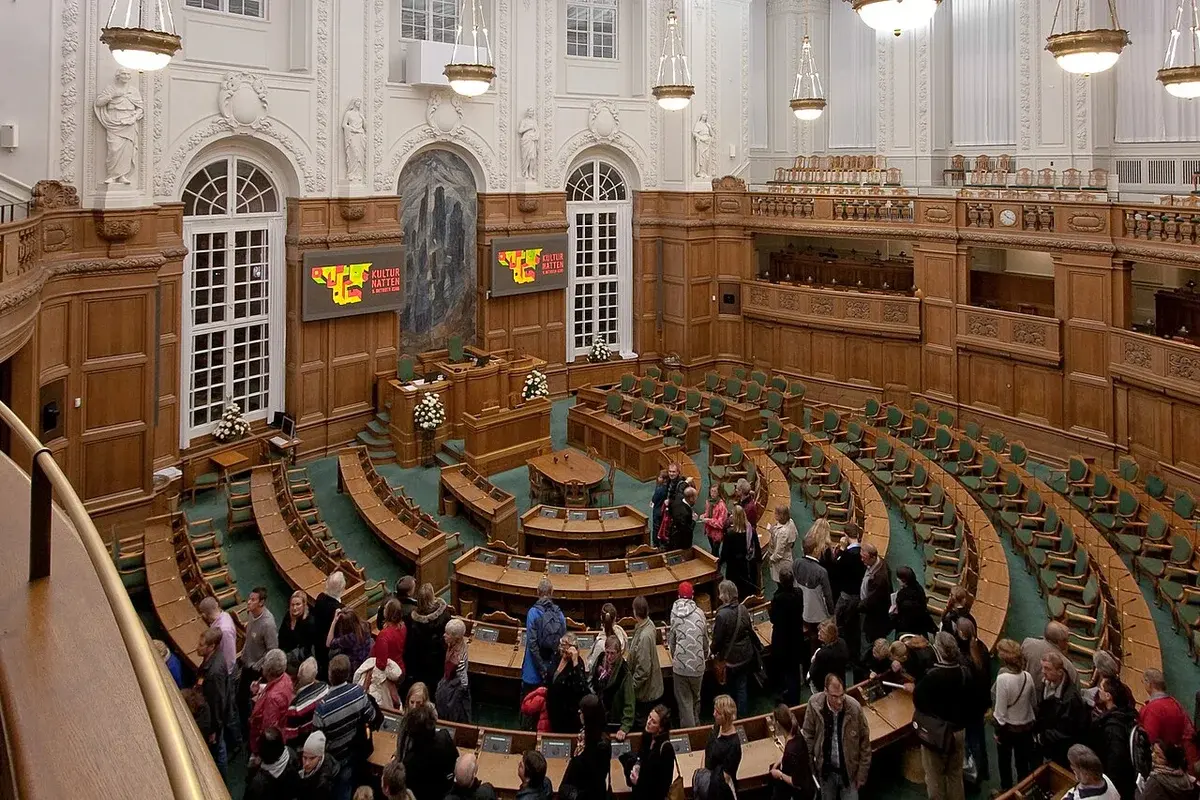 Interior of the Danish Parliament debate chamber with visitors inside