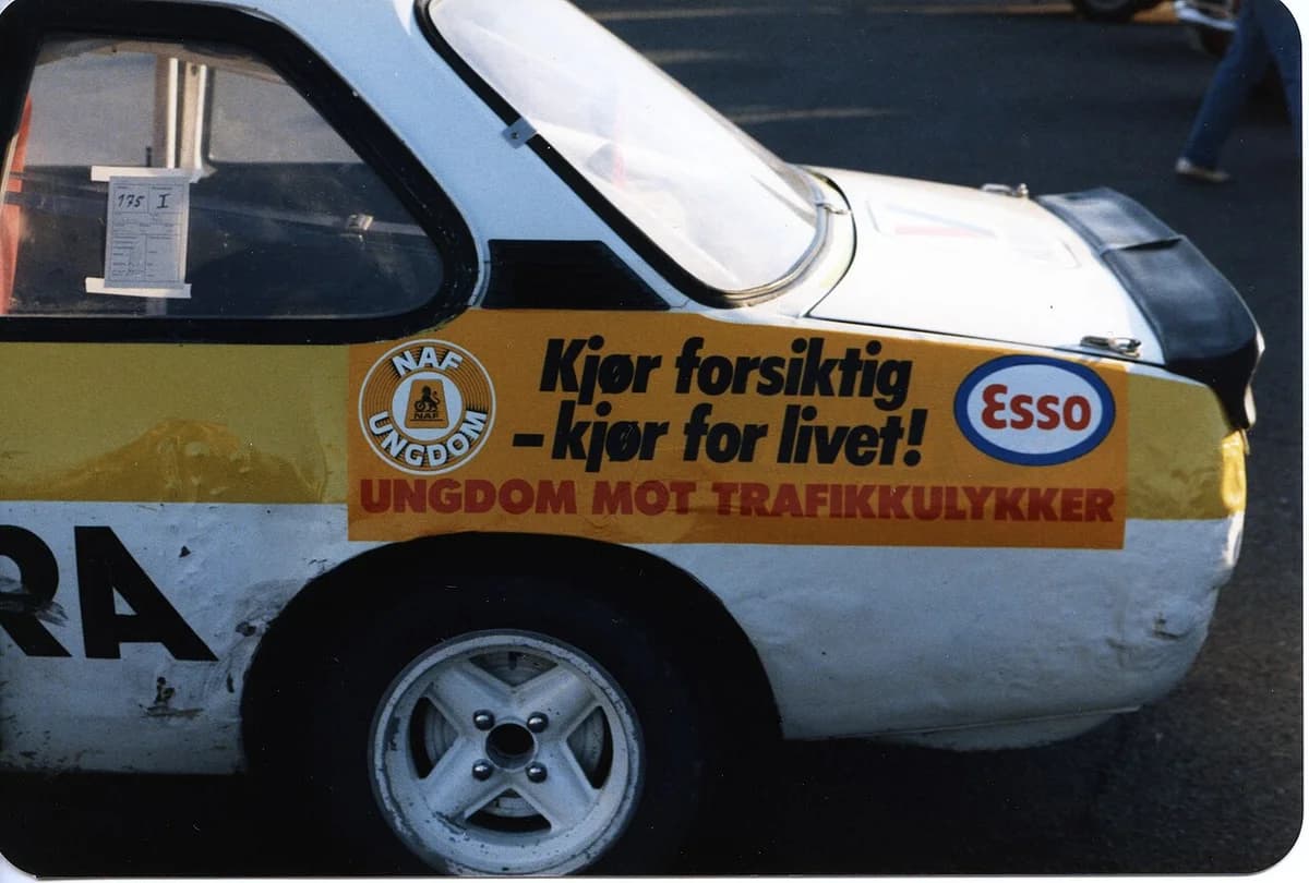 Side of a car with NAF and Esso road safety campaign stickers.